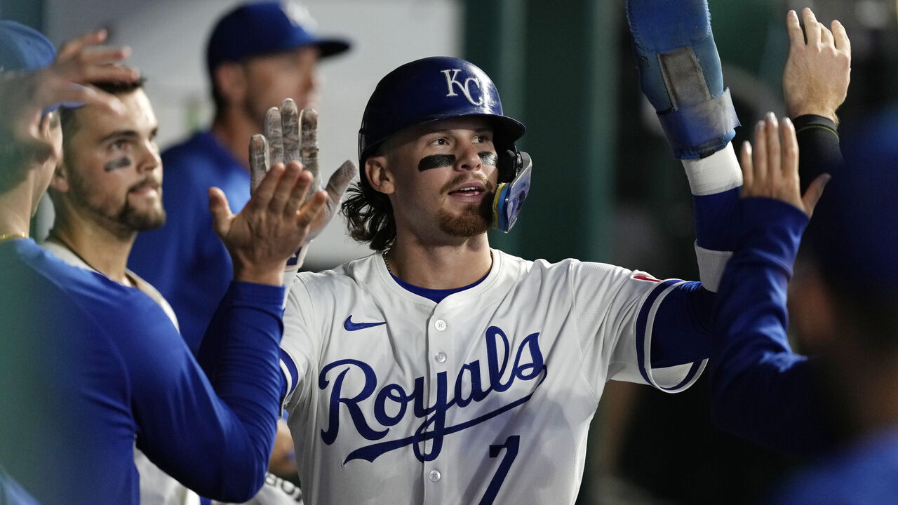 KANSAS CITY, MISSOURI - AUGUST 06: Bobby Witt Jr. #7 of the Kansas City Royals is congratulated after scoring against the Boston Red Sox at Kauffman Stadium on August 06, 2024 in Kansas City, Missouri.