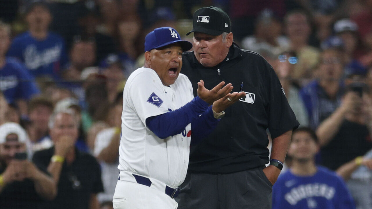 LOS ANGELES, CALIFORNIA - AUGUST 07: Manager Dave Roberts #30 of the Los Angeles Dodgers argues an interference call on Miguel Rojas #11 from umpire Hunter Wendelstedt, allowing Alec Bohm #28 of the Philadelphia Phillies to third, during the sixth inning at Dodger Stadium on August 07, 2024 in Los Angeles, California.