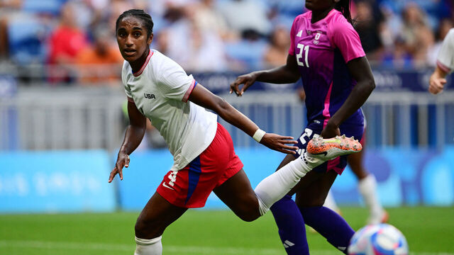 US' defender #04 Naomi Girma (L)and Germany's forward #21 Nicole Anyomi compete for the ball during the women's semi-final football match between USA and Germany during the Paris 2024 Olympic Games at the Lyon Stadium in Lyon on August 6, 2024.