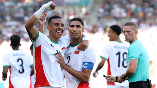 (From L) Morocco's forward #09 Soufiane Rahimi celebrates scoring the opening goal with Morocco's defender #02 Achraf Hakimi in the men's bronze medal football match between Egypt and Morocco during the Paris 2024 Olympic Games at the La Beaujoire Stadium in Nantes on August 8, 2024.