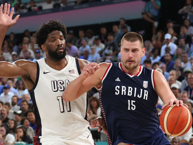 PARIS, FRANCE - AUGUST 08: Nikola Jokic #15 of Team Serbia drives past Joel Embiid #11 of Team United States during a Men's basketball semifinals match between Team United States and Team Serbia on day thirteen of the Olympic Games Paris 2024 at Bercy Arena on August 08, 2024 in Paris, France.