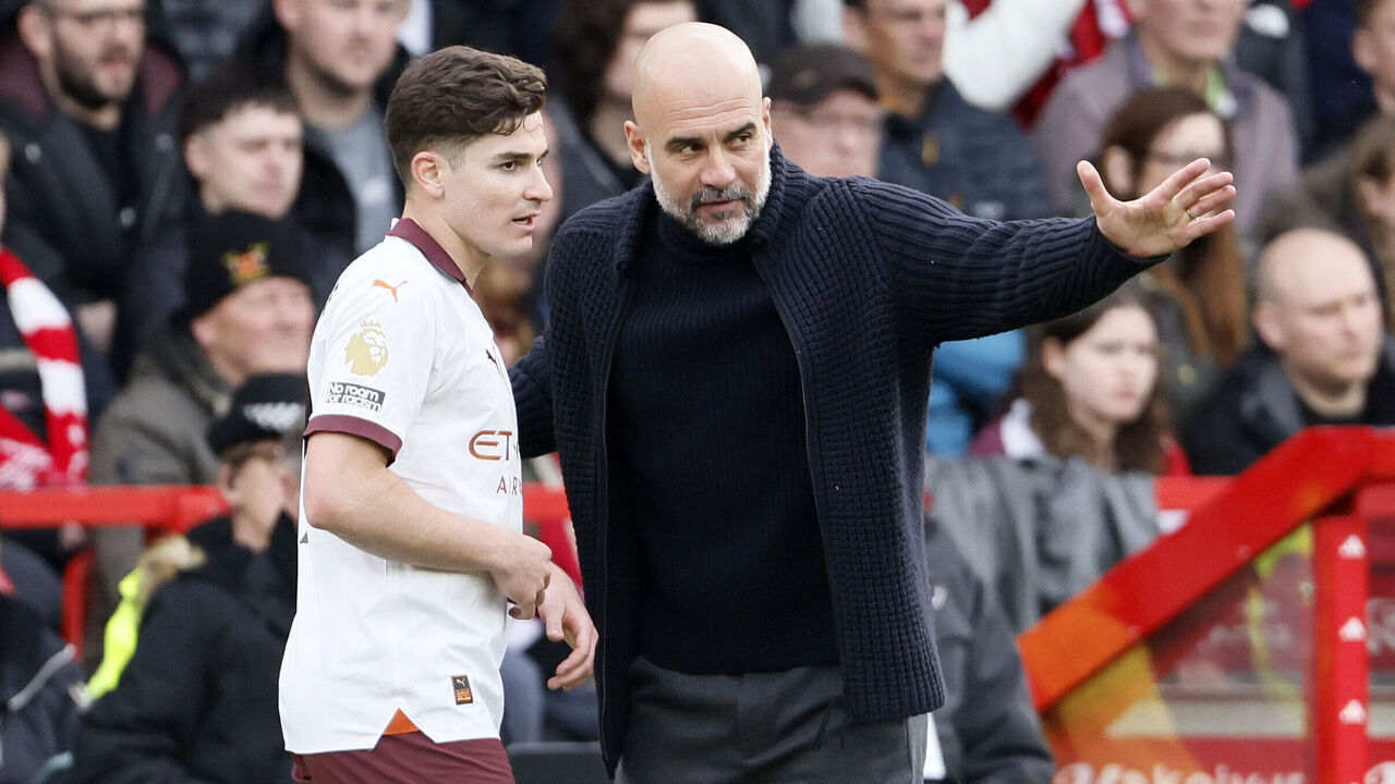 NOTTINGHAM, ENGLAND - APRIL 28: Julian Alvarez of Manchester City and Pep Guardiola, Manager of Manchester City on the side line during the Premier League match between Nottingham Forest and Manchester City at City Ground on April 28, 2024 in Nottingham, England.