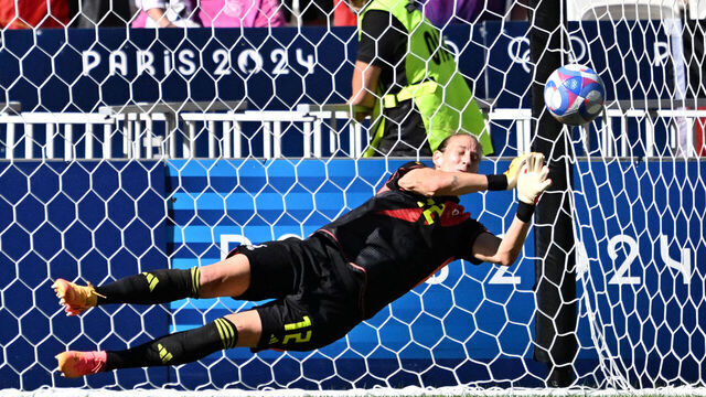 Germany's goalkeeper #12 Ann-Katrin Berger deflects the goal attempted by Spain's midfielder #11 Alexia Putellas (R) from the penalty spot in the women's bronze medal football match between Spain and Germany during the Paris 2024 Olympic Games at the Lyon Stadium in Lyon on August 9, 2024.