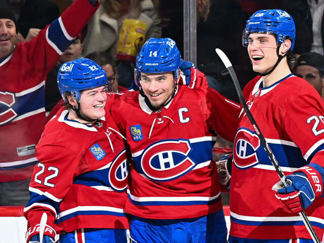 MONTREAL, CANADA - FEBRUARY 10: Nick Suzuki #14 of the Montreal Canadiens celebrates his goal with teammates Cole Caufield #22 (L) and Juraj Slafkovsky #20 (R) during the second period against the Dallas Stars at the Bell Centre on February 10, 2024 in Montreal, Quebec, Canada. The Dallas Stars defeated the Montreal Canadiens 3-2.