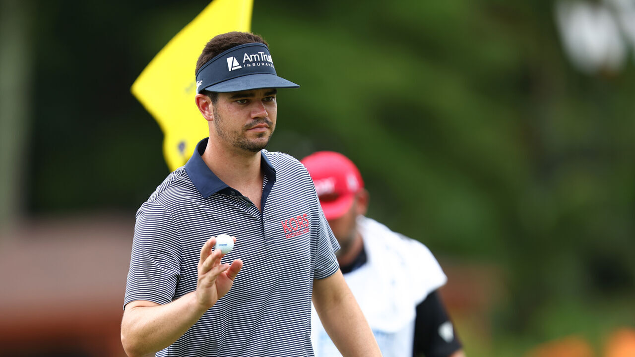 GREENSBORO, NORTH CAROLINA - AUGUST 09: Beau Hossler of the United States acknowledges the crowd on the 16th green during the first round of the Wyndham Championship at Sedgefield Country Club on August 09, 2024 in Greensboro, North Carolina.