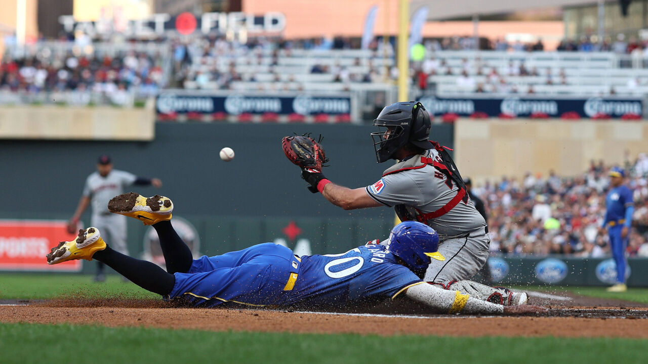 MINNEAPOLIS, MN - AUGUST 09: Austin Hedges #27 of the Cleveland Guardians unsuccessfully attempts the tag on Willi Castro #50 of the Minnesota Twins in the first inning during game two of a double header at Target Field on August 09, 2024 in Minneapolis, Minnesota.