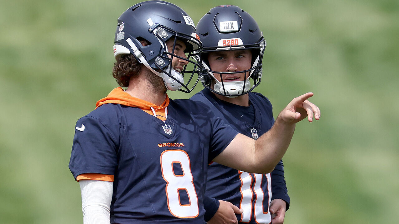 ENGLEWOOD, COLORADO - JUNE 04: Quarterbacks Jarrett Stidham #8 and Bo Nix #10 of the Denver Broncos confer during Denver Broncos OTA Offseason Workouts at Centura Health Training Center on June 04, 2024 in Englewood, Colorado.