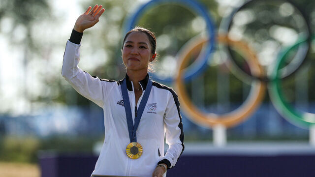 New Zealand's gold medallist Lydia Ko celebrates with her medal on the podium during the women's golf individual stroke play medal ceremony of the Paris 2024 Olympic Games at Le Golf National in Guyancourt, south-west of Paris, on August 10, 2024.