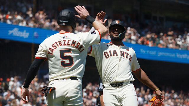SAN FRANCISCO, CALIFORNIA - AUGUST 10: Mike Yastrzemski #5 and Jerar Encarnacion #59 of the San Francisco Giants celebrate after scoring on a double by Brett Wisely #0 in the bottom of the fifth inning against the Detroit Tigers at Oracle Park on August 10, 2024 in San Francisco, California.