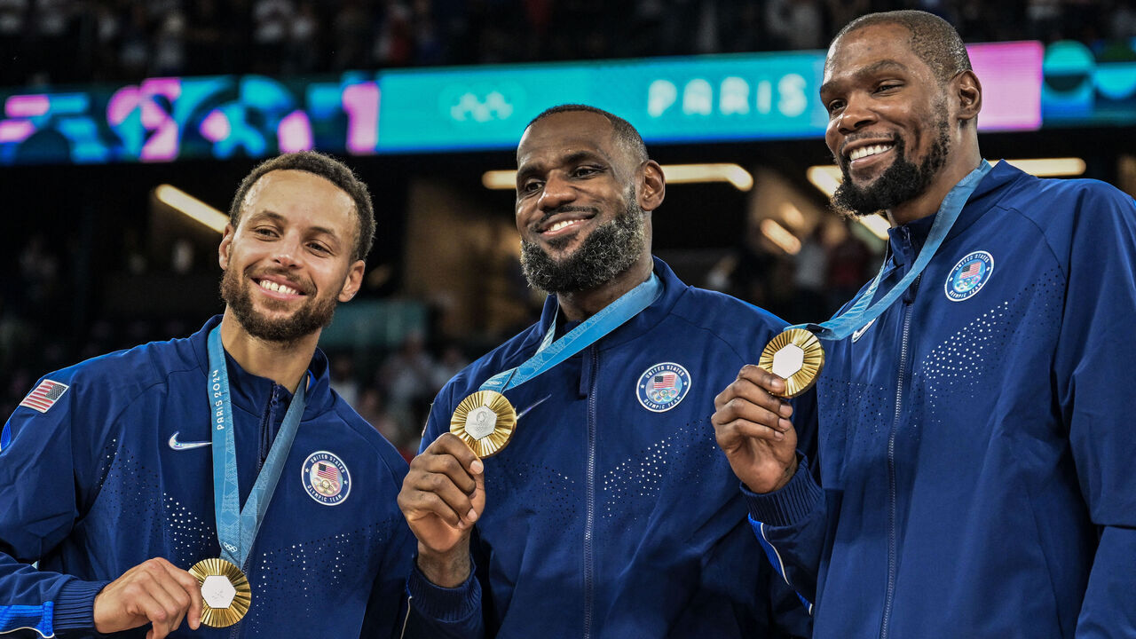 TOPSHOT - Gold medallists (From L) USA's #04 Stephen Curry, USA's #06 LeBron James and USA's #07 Kevin Durant pose after the men's Gold Medal basketball match between France and USA during the Paris 2024 Olympic Games at the Bercy Arena in Paris on August 10, 2024.