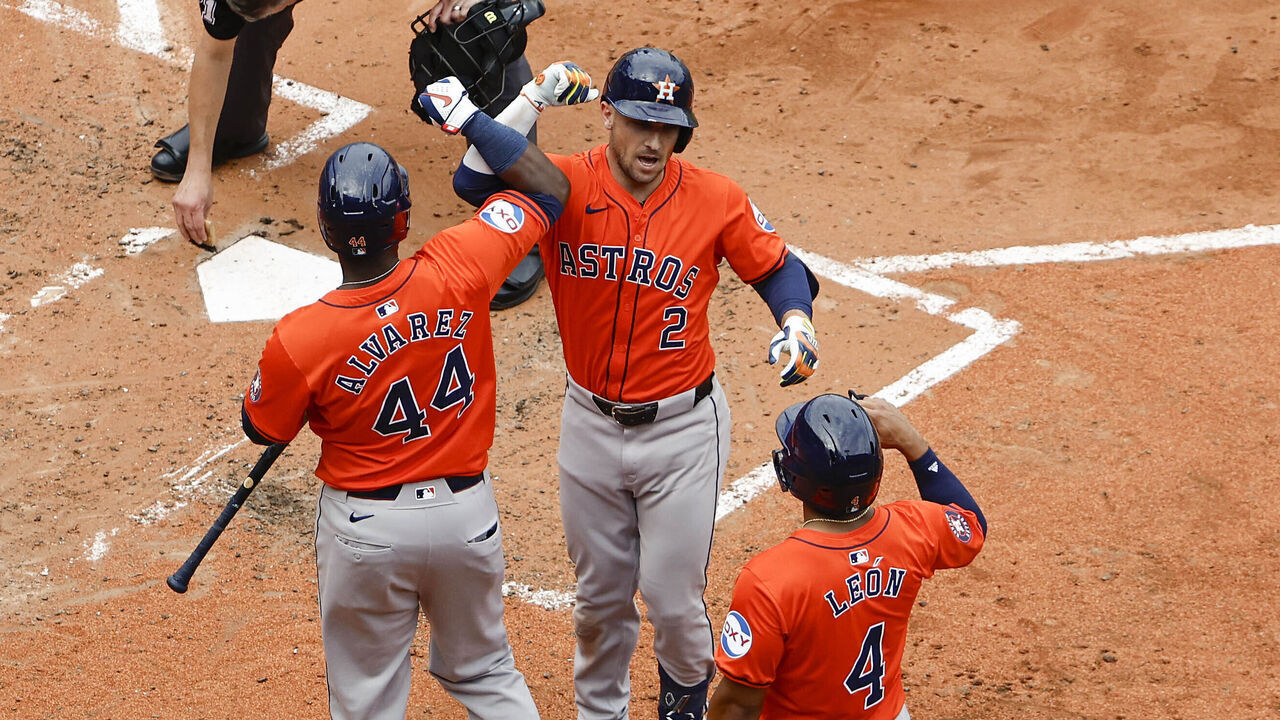 BOSTON, MA - AUGUST 11: As catcher Connor Wong #12 of the Boston Red Sox looks away, Alex Bregman #2 of the Houston Astros celebrates his three-run home run with teammates Yordan Alvarez #44, Pedro León #4 and Jose Altuve #27 during the fifth inning at Fenway Park on August 11, 2024 in Boston, Massachusetts.