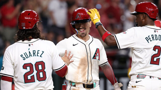 PHOENIX, ARIZONA - AUGUST 10: Corbin Carroll #7 of the Arizona Diamondbacks celebrates with Eugenio Suárez #28 and Geraldo Perdomo #2 after hitting a three-run home run during the seventh inning /aph at Chase Field on August 10, 2024 in Phoenix, Arizona.