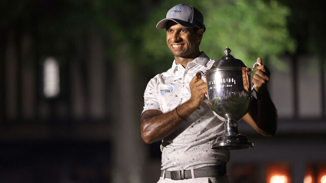 GREENSBORO, NORTH CAROLINA - AUGUST 11: Aaron Rai of England poses with the trophy after the final round of the Wyndham Championship at Sedgefield Country Club on August 11, 2024 in Greensboro, North Carolina.