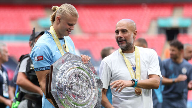 LONDON, ENGLAND - AUGUST 10: Pep Guardiola Manager / Head Coach of Manchester City and Erling Haaland of Manchester City with the trophy after the 2024 FA Community Shield match between Manchester United and Manchester City at Wembley Stadium on August 10, 2024 in London, England.