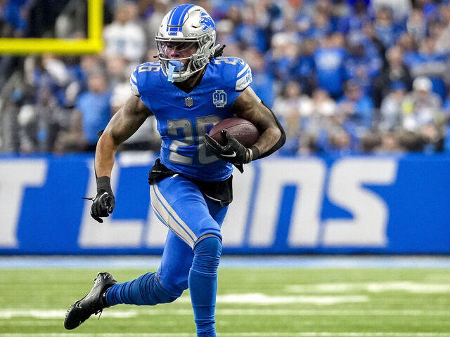 DETROIT, MICHIGAN - JANUARY 21: Jahmyr Gibbs #26 of the Detroit Lions runs the ball against the Tampa Bay Buccaneers at Ford Field on January 21, 2024 in Detroit, Michigan.