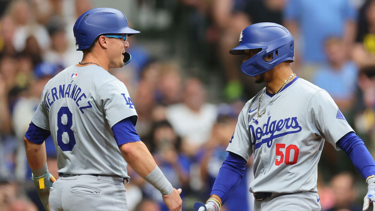 MILWAUKEE, WISCONSIN - AUGUST 12: Mookie Betts #50 of the Los Angeles Dodgers is congratulated by Enrique Hernández #8 following a two run home run against the Milwaukee Brewers during the third inning at American Family Field on August 12, 2024 in Milwaukee, Wisconsin.