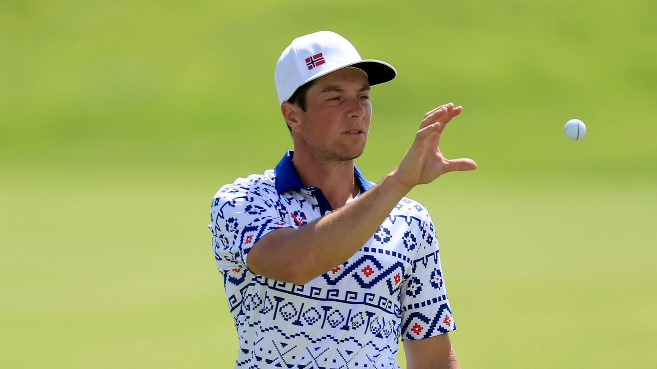 PARIS, FRANCE - AUGUST 04: Viktor Hovland of Norway catches his ball on the 18th hole on day nine of the Olympic Games Paris 2024 at Le Golf National on August 04, 2024 in Paris, France.