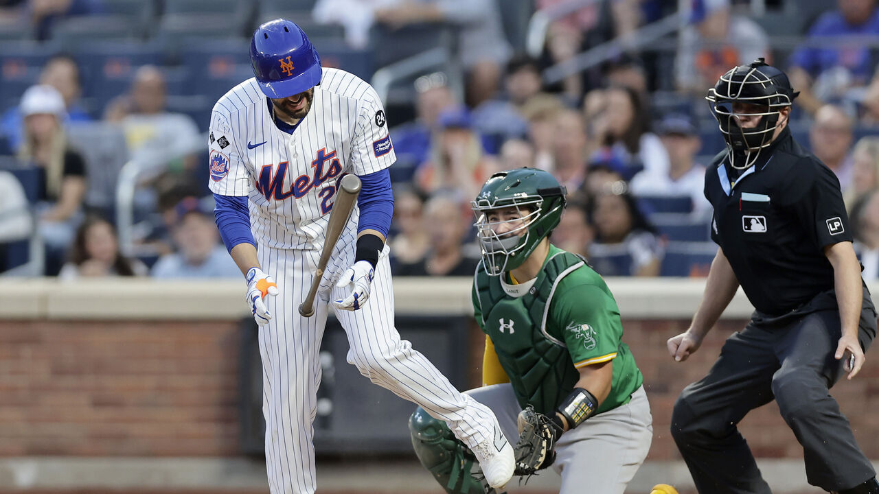 NEW YORK, NEW YORK - AUGUST 13: J.D. Martinez #28 of the New York Mets is hit by a pitch during the second inning against the Oakland Athletics at Citi Field on August 13, 2024 in New York City.