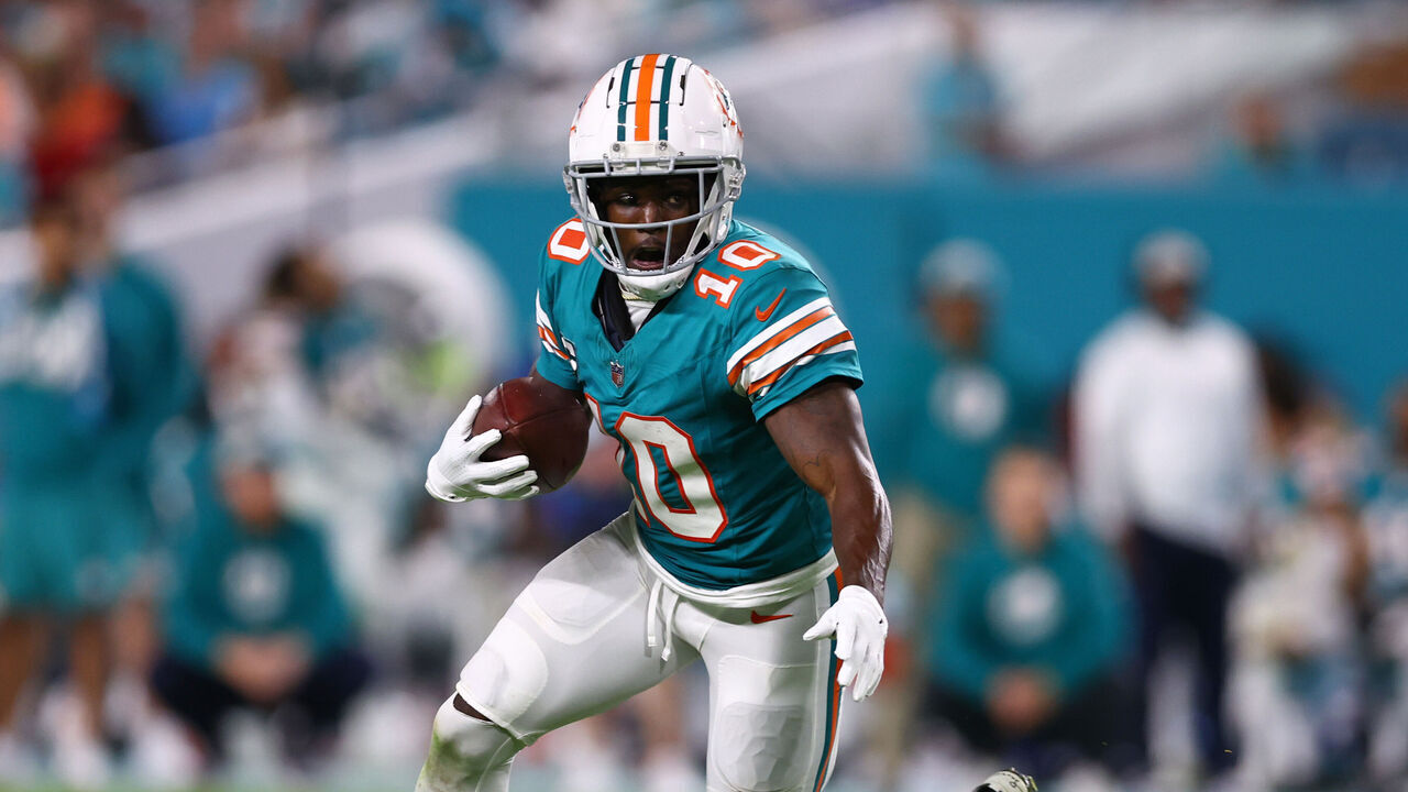 MIAMI GARDENS, FLORIDA - DECEMBER 24: Tyreek Hill #10 of the Miami Dolphins carries the ball against the Dallas Cowboys during the fourth quarter of the game at Hard Rock Stadium on December 24, 2023 in Miami Gardens, Florida.