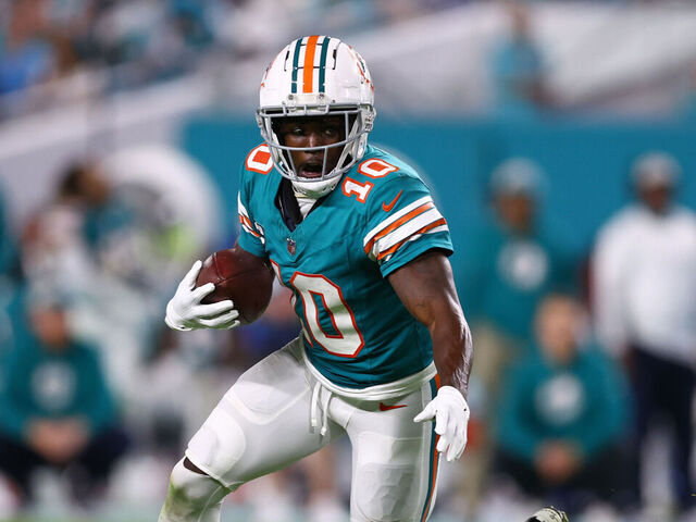 MIAMI GARDENS, FLORIDA - DECEMBER 24: Tyreek Hill #10 of the Miami Dolphins carries the ball against the Dallas Cowboys during the fourth quarter of the game at Hard Rock Stadium on December 24, 2023 in Miami Gardens, Florida.