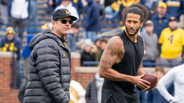 ANN ARBOR, MI - APRIL 02: Colin Kaepernick interacts with Michigan Wolverine head coach Jim Harbaugh during a throwing exhibition during half time of the Michigan spring football game at Michigan Stadium on April 2, 2022 in Ann Arbor, Michigan.