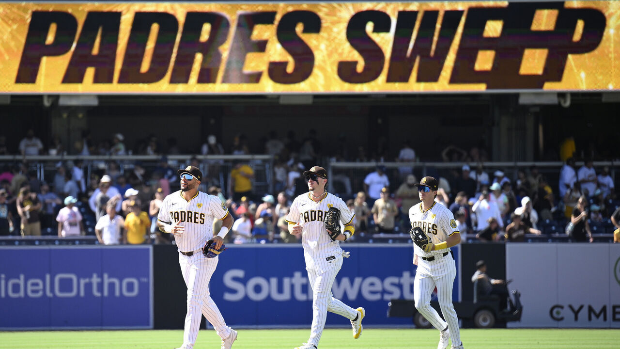 SAN DIEGO, CALIFORNIA - AUGUST 14: (L-R) David Peralta #24 of the San Diego Padres runs off the field ahead of Jackson Merrill #3 and Bryce Johnson #27 after defeating the Pittsburgh Pirates 8-2 at Petco Park on August 14, 2024 in San Diego, California.
