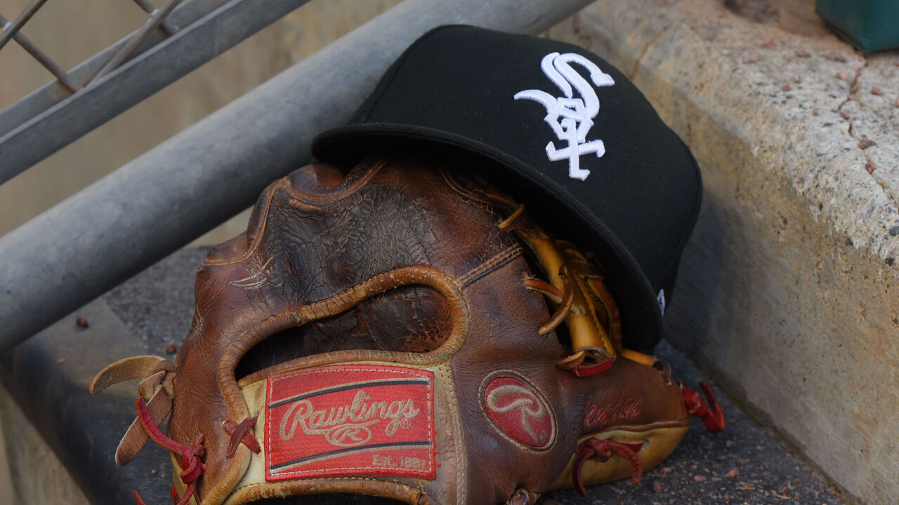 DETROIT, MI - AUGUST 05: A detailed view of a Chicago White Sox baseball hat and a Rawlings glove sitting in the dugout during the game against the Detroit Tigers at Comerica Park on August 5, 2019 in Detroit, Michigan. The White Sox defeated the Tigers 7-4.
