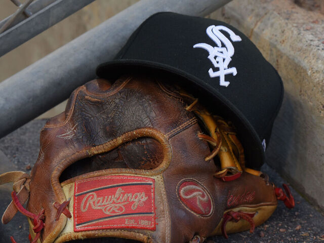 DETROIT, MI - AUGUST 05: A detailed view of a Chicago White Sox baseball hat and a Rawlings glove sitting in the dugout during the game against the Detroit Tigers at Comerica Park on August 5, 2019 in Detroit, Michigan. The White Sox defeated the Tigers 7-4.