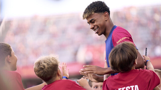 BARCELONA, SPAIN - AUGUST 12: Lamine Yamal of FC Barcelona greets children prior to the Joan Gamper Trophy match between FC Barcelona and AS Monaco at Estadi Olimpic Lluis Companys on August 12, 2024 in Barcelona, Spain.