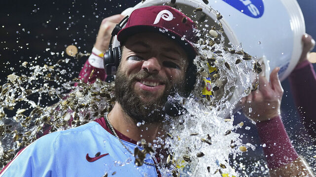 PHILADELPHIA, PENNSYLVANIA - AUGUST 15: Weston Wilson #37 of the Philadelphia Phillies has water poured on him during his postgame press conference after hitting for the cycle against the Washington Nationals at Citizens Bank Park on August 15, 2024 in Philadelphia, Pennsylvania. The Phillies defeated the Nationals 13-3.