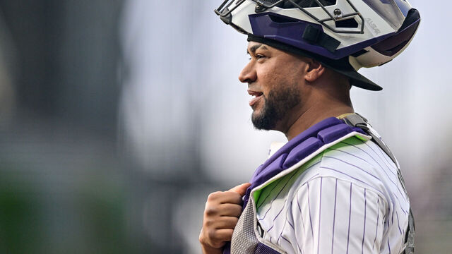 DENVER, COLORADO - AUGUST 7: Elias Diaz #35 of the Colorado Rockies looks on and smiles before catching a game against the New York Mets at Coors Field on August 7, 2024 in Denver, Colorado.