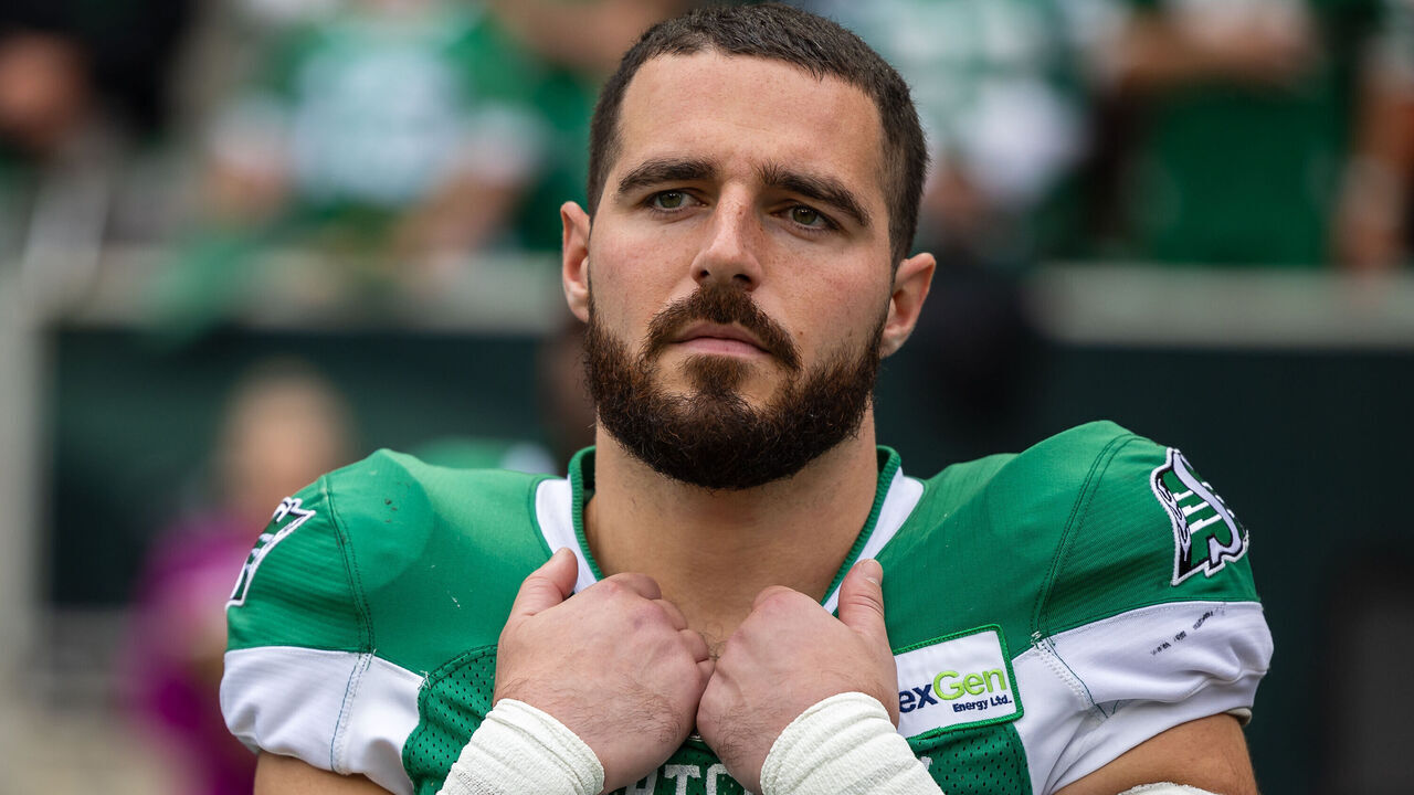 REGINA, CANADA - AUGUST 20: Thomas Bertrand-Hudlooks on from #30 of the Saskatchewan Roughriders looks on from the sideline before the game between the BC Lions and Saskatchewan Roughriders at Mosaic Stadium looks on from August 20, 2023 in Regina, Canada.