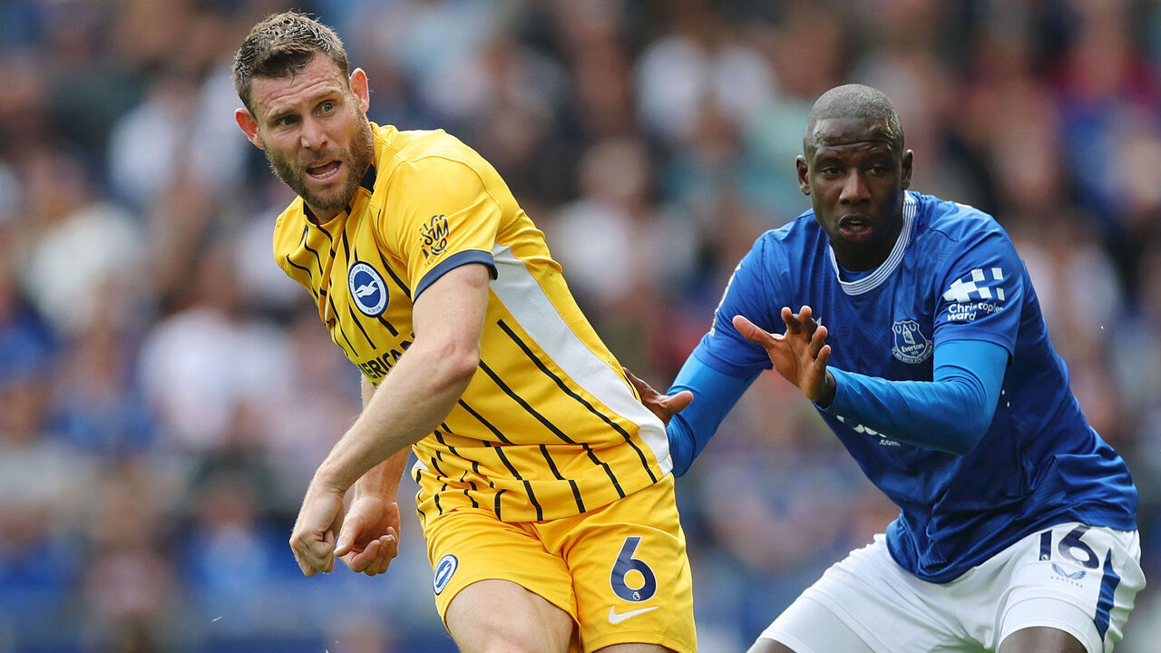 LIVERPOOL, ENGLAND - AUGUST 17: James Milner of Brighton & Hove Albion passes the ball under pressure from Abdoulaye Doucoure of Everton during the Premier League match between Everton FC and Brighton & Hove Albion FC at Goodison Park on August 17, 2024 in Liverpool, England.