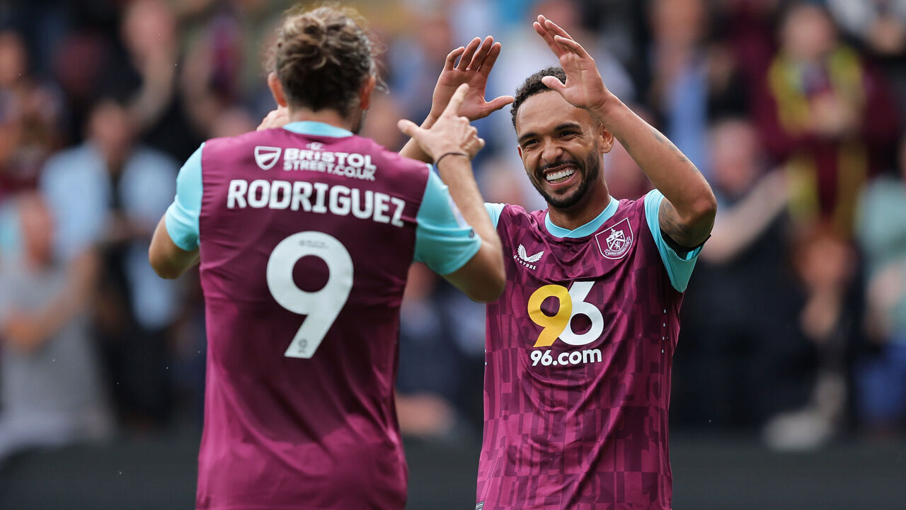 BURNLEY, ENGLAND - AUGUST 17: Vitinho of Burnley celebrates with teammate Jay Rodriguez after the teams second goal scored by Luca Koleosho of Burnley (not pictured) during the Sky Bet Championship match between Burnley FC and Cardiff City FC at on August 17, 2024 in Burnley, England.