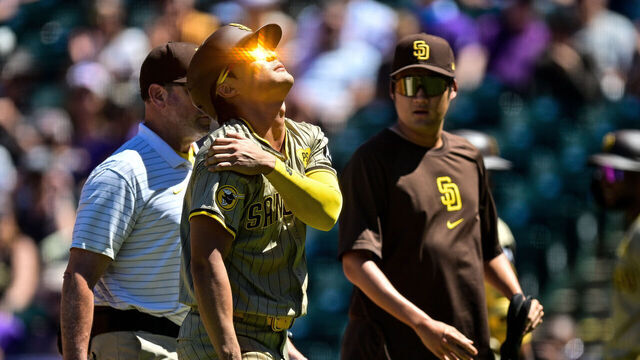 DENVER, COLORADO - AUGUST 18: Ha-Seong Kim #7 of the San Diego Padres comes out of the game with an apparent upper body injury after sliding to avoid a pickoff attempt at first base in the third inning against the Colorado Rockies at Coors Field on August 18, 2024 in Denver, Colorado.