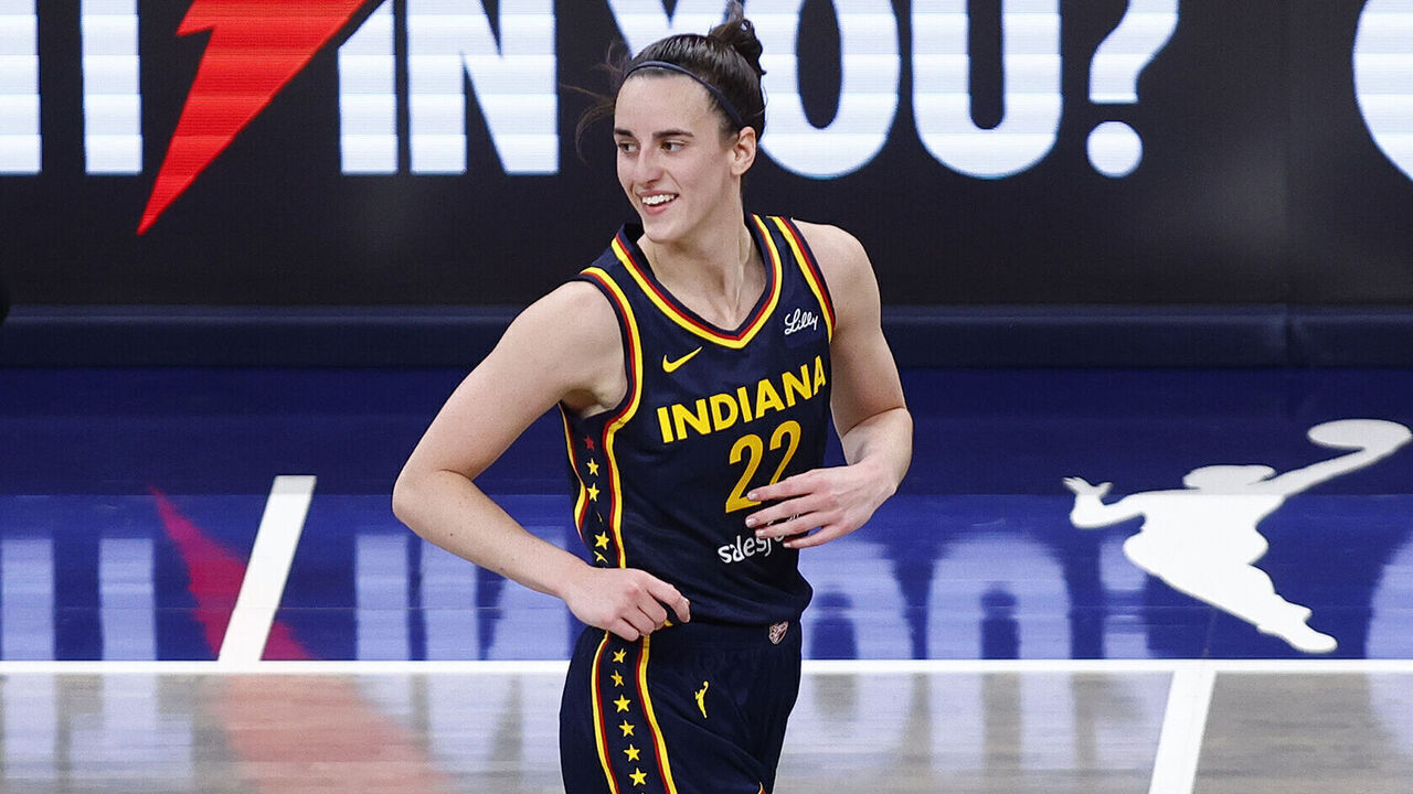 INDIANAPOLIS, IN - AUGUST 18: Indiana Fever guard Caitlin Clark (22) is all smiles after dishing and assist to Indiana Fever guard Lexie Hull (10) to knock down a three pointer in the fourth quarter of play during a WNBA game between the Seattle Storm and the Indiana Fever on August 18, 2024 at Gainbridge Fieldhouse in Indianapolis, IN.