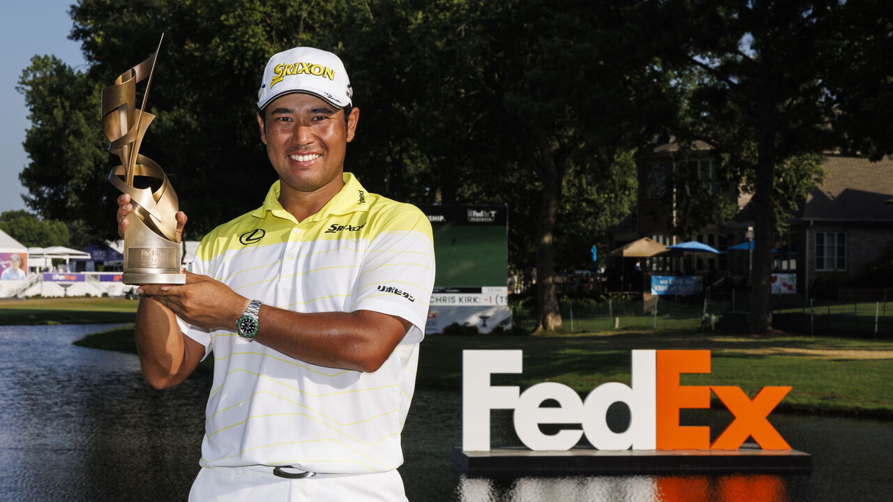 MEMPHIS, TENNESSEE - AUGUST 18: Hideki Matsuyama of Japan poses with the trophy on the 18th green after winning the FedEx St. Jude Championship at TPC Southwind on August 18, 2024 in Memphis, Tennessee.