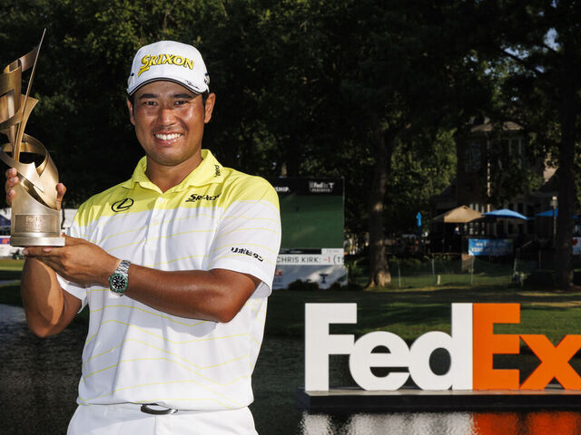 MEMPHIS, TENNESSEE - AUGUST 18: Hideki Matsuyama of Japan poses with the trophy on the 18th green after winning the FedEx St. Jude Championship at TPC Southwind on August 18, 2024 in Memphis, Tennessee.