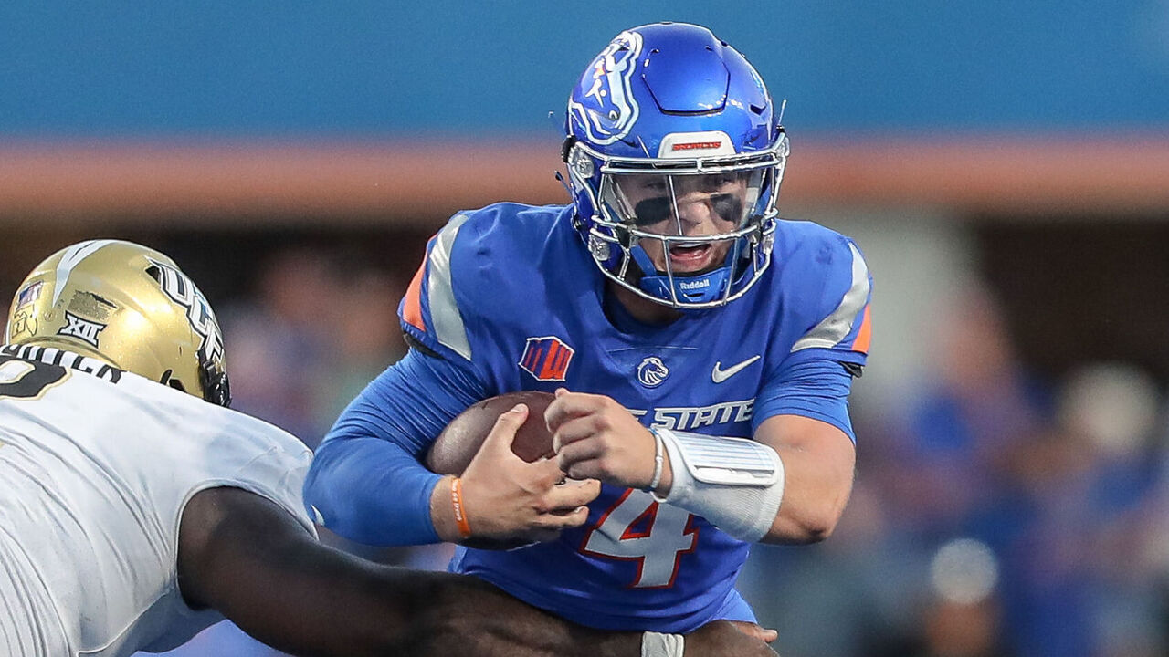 BOISE, ID - SEPTEMBER 9: Quarterback Maddux Madsen #4 of the Boise State Broncos scrambles away from defensive tackle Lee Hunter #2 of the UCF Knightsduring second half action at Albertsons Stadium on September 9, 2023 in Boise, Idaho. UCF won the game 18-16.