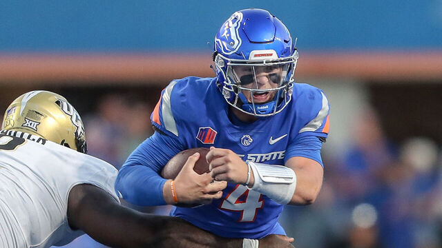 BOISE, ID - SEPTEMBER 9: Quarterback Maddux Madsen #4 of the Boise State Broncos scrambles away from defensive tackle Lee Hunter #2 of the UCF Knightsduring second half action at Albertsons Stadium on September 9, 2023 in Boise, Idaho. UCF won the game 18-16.