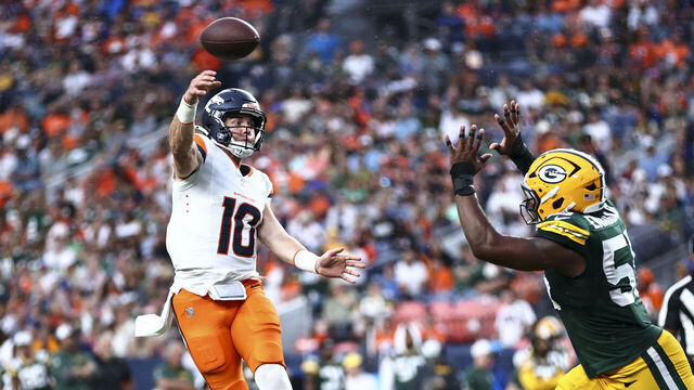DENVER, COLORADO - AUGUST 18: Bo Nix #10 of the Denver Broncos throws a touchdown pass to Tim Patrick #12 in the second quarter during the preseason game against the Green Bay Packers at Empower Field At Mile High on August 18, 2024 in Denver, Colorado.