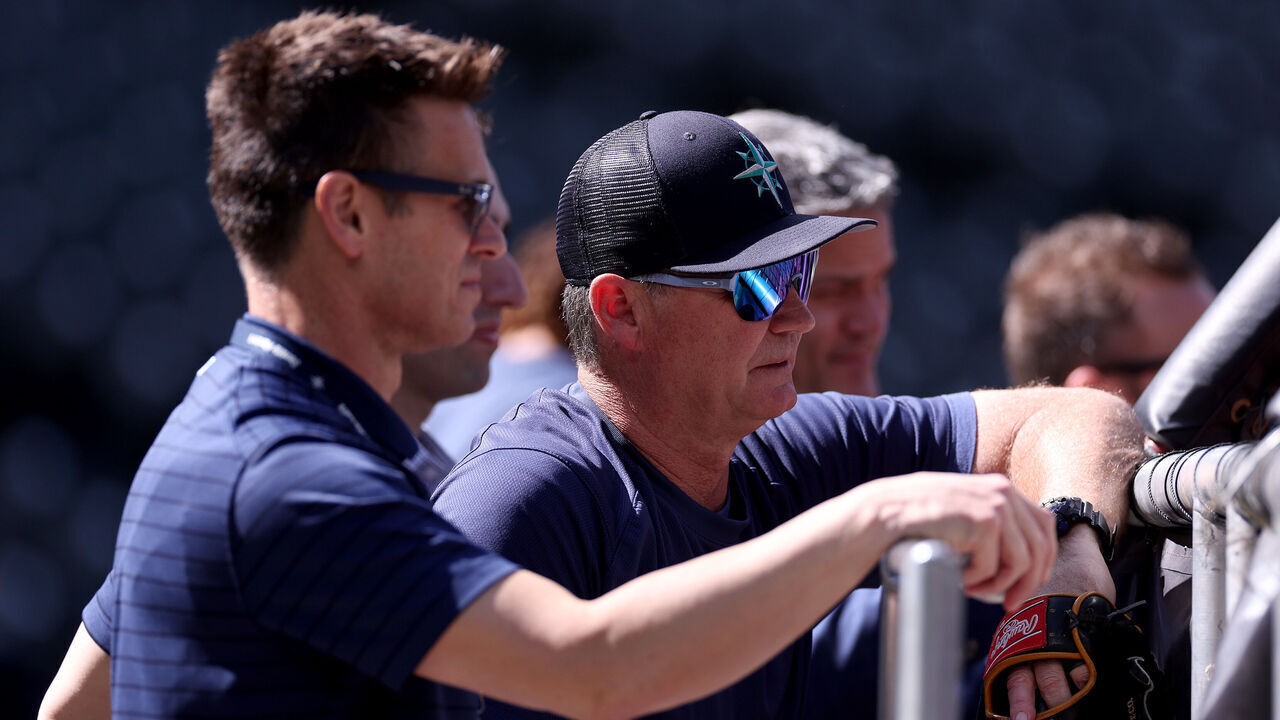 SEATTLE, WASHINGTON - JULY 18: General manager Jerry Dipoto of the Seattle Mariners watches batting practice with manager Scott Servais #9 at T-Mobile Park on July 18, 2023 in Seattle, Washington.