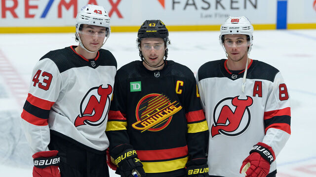 VANCOUVER, CANADA - DECEMBER 5: Brothers Luke Hughes #43 of the New Jersey Devils Quinn Hughes #43 of the Vancouver Canucks and Jack Hughes #86 of the New Jersey Devils pose for a photo prior to their NHL game at Rogers Arena on December 5, 2023 in Vancouver, British Columbia, Canada.