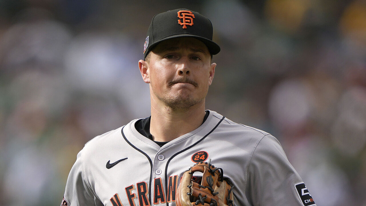 OAKLAND, CALIFORNIA - AUGUST 17: Matt Chapman #26 of the San Francisco Giants walks off the field at the end of the fourth inning against the Oakland Athletics at the Oakland Coliseum on August 17, 2024 in Oakland, California. Players in major league baseball for the first time is wearing their jersey numbers on their caps.