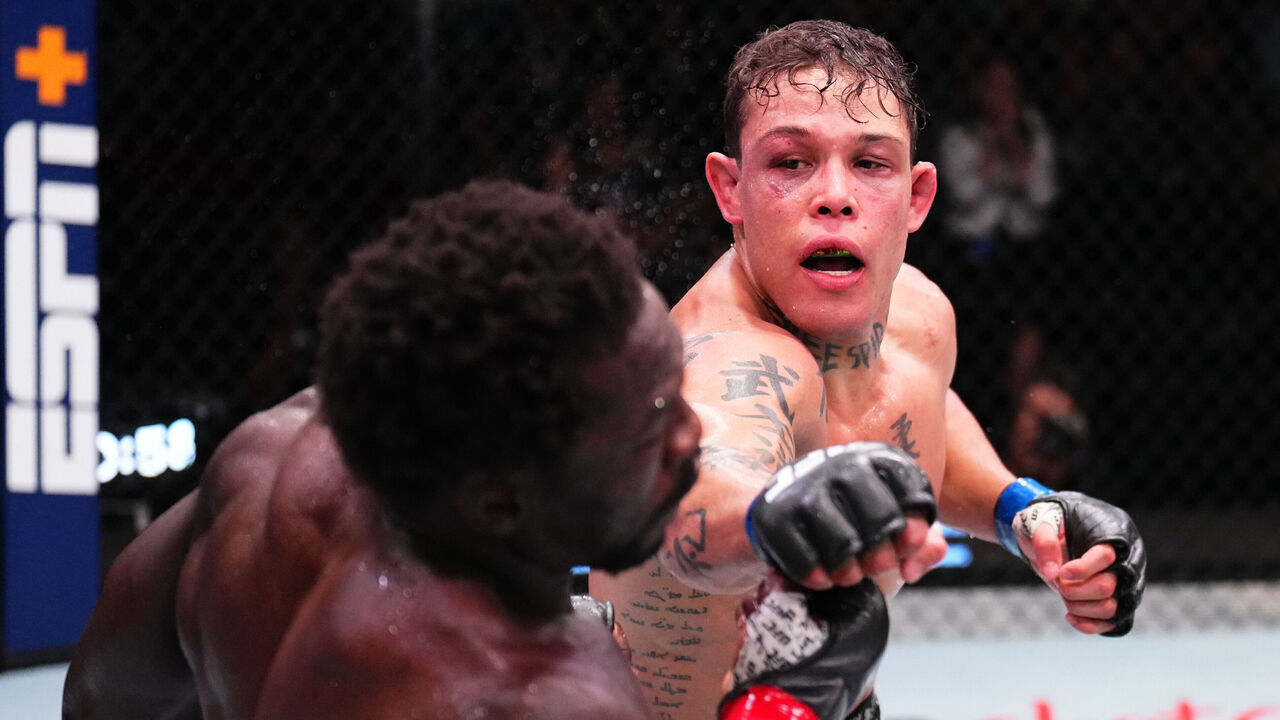 LAS VEGAS, NEVADA - AUGUST 24: (R-L) Caio Borralho of Brazil punches Jared Cannonier in a middleweight fight during the UFC Fight Night event at UFC APEX on August 24, 2024 in Las Vegas, Nevada.