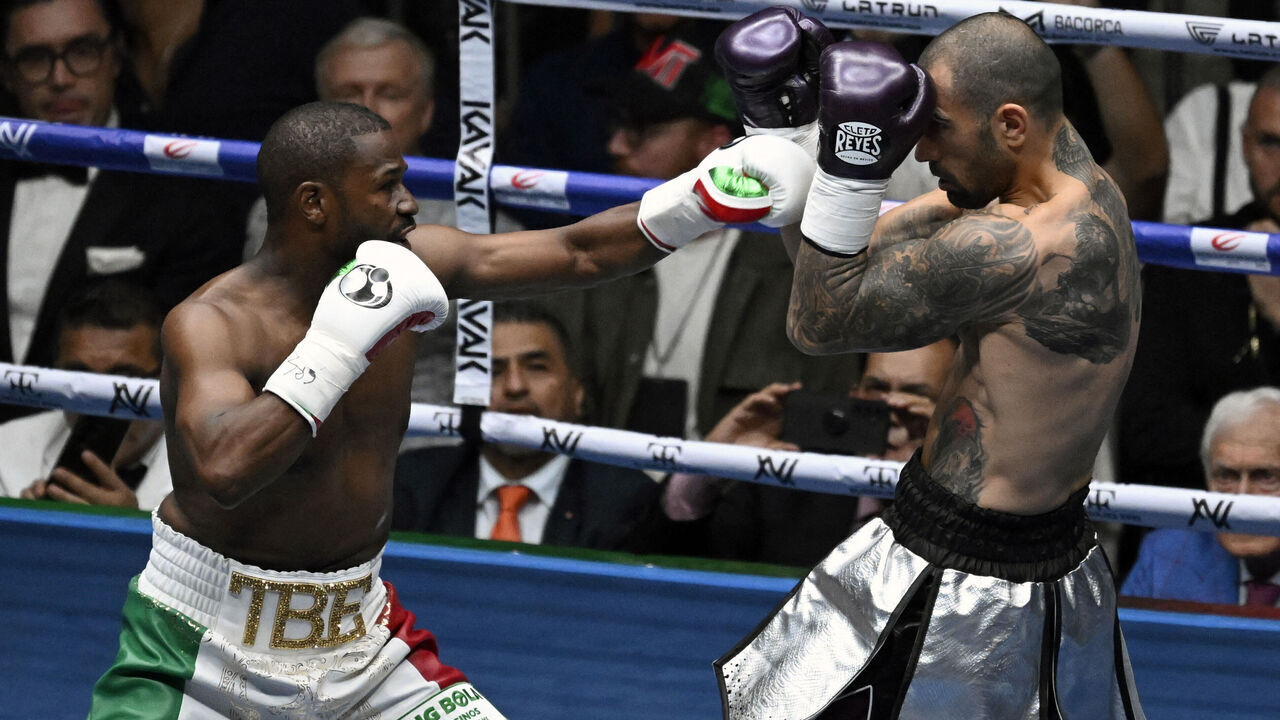 US boxer Floyd Mayweather Jr. (L) fights with US boxer John Gotti III during an exhibition fight at the Arena Ciudad de Mexico in Mexico City on August 24, 2024.