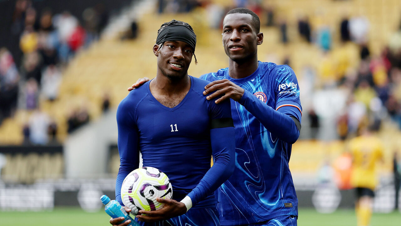 WOLVERHAMPTON, ENGLAND - AUGUST 25: Noni Madueke of Chelsea celebrates victory with the match ball, after scoring a hat-trick, and with teammate Nicolas Jackson after the Premier League match between Wolverhampton Wanderers FC and Chelsea FC at Molineux on August 25, 2024 in Wolverhampton, England.