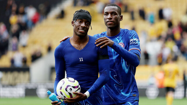 WOLVERHAMPTON, ENGLAND - AUGUST 25: Noni Madueke of Chelsea celebrates victory with the match ball, after scoring a hat-trick, and with teammate Nicolas Jackson after the Premier League match between Wolverhampton Wanderers FC and Chelsea FC at Molineux on August 25, 2024 in Wolverhampton, England.
