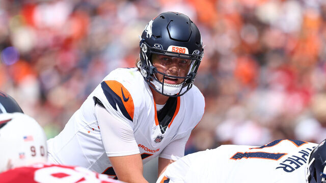 DENVER, COLORADO - AUGUST 25: Zach Wilson #4 of the Denver Broncos looks at the Arizona Cardinals defense in the second quarter of a preseason game at Empower Field At Mile High on August 25, 2024 in Denver, Colorado.