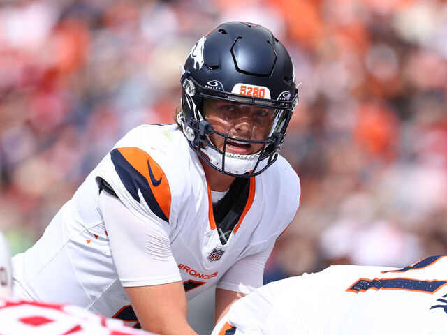 DENVER, COLORADO - AUGUST 25: Zach Wilson #4 of the Denver Broncos looks at the Arizona Cardinals defense in the second quarter of a preseason game at Empower Field At Mile High on August 25, 2024 in Denver, Colorado.